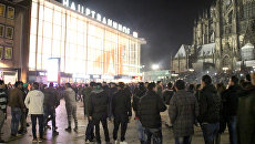 Люди у железнодорожной станции города Кёльна, Германия. 31 декабря 2015. Архивное фото Люди у железнодорожной станции города Кёльна, Германия. 31 декабря 2015. Архивное фото