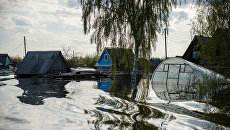 Частные дома, подтопленные в результате сильного поднятия воды в реках. Архивное фото Частные дома, подтопленные в результате сильного поднятия воды в реках. Архивное фото