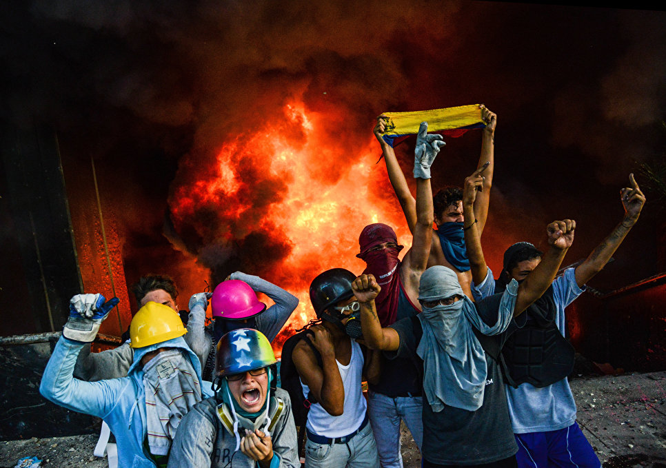 Протестующие подожгли здание Верховного суда во время митинга против президента Николаса Мадуро в Каракасе Протестующие подожгли здание Верховного суда во время митинга против президента Николаса Мадуро в Каракасе