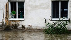 Подтопленный дом в Уссурийске. Архивное фото Подтопленный дом в Уссурийске. Архивное фото