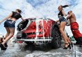 Промо модели у автомобиля на стенде Mazda во время автосалона Vladivostok International Autosalon Промо модели у автомобиля на стенде Mazda во время автосалона Vladivostok International Autosalon