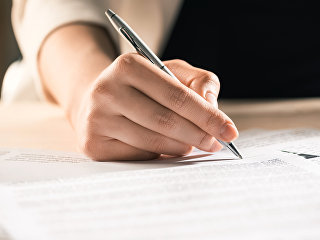 Мужчина подписывает документы Мужчина подписывает документы