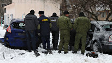 Эксперты работают на месте взрыва, который произошел на автостоянке во дворе жилого дома на улице Челюскинцев в Донецке. 3 марта 2018 Эксперты работают на месте взрыва, который произошел на автостоянке во дворе жилого дома на улице Челюскинцев в Донецке. 3 марта 2018
