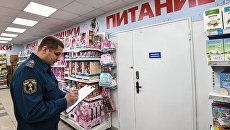 Сотрудник государственного пожарного надзора во время проверки пожарной безопасности в торгово-развлекательном центре Сотрудник государственного пожарного надзора во время проверки пожарной безопасности в торгово-развлекательном центре