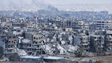 Разрушенные дома в пригороде Дамаска у лагеря палестинских беженцев Ярмук. Архивное фото Разрушенные дома в пригороде Дамаска у лагеря палестинских беженцев Ярмук. Архивное фото