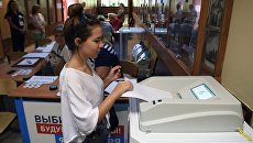 Избирательница в единый день голосования на избирательном участке в Москве Избирательница в единый день голосования на избирательном участке в Москве